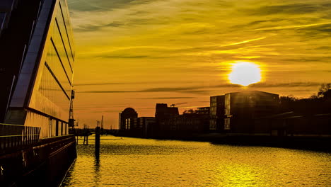 time lapse shot of golden sunset at port in hamburg in the evening