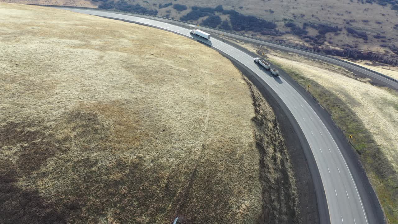 High-Angle View of Mountain Highway with Trucks