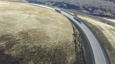high-angle view of mountain highway with trucks