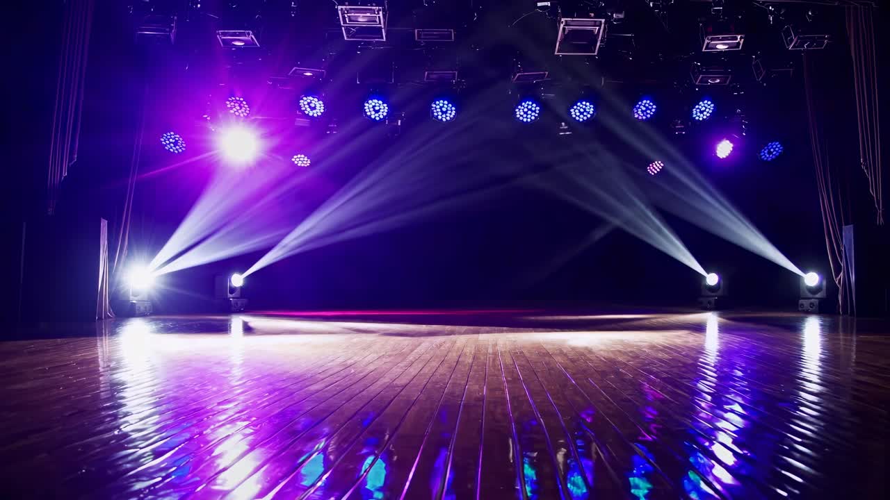 Empty Stage with Dynamic Moving Spotlights and Colorful Light Beams