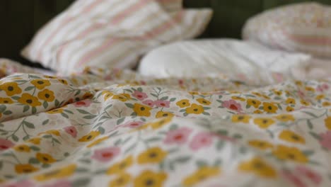 messy bed with floral bedding