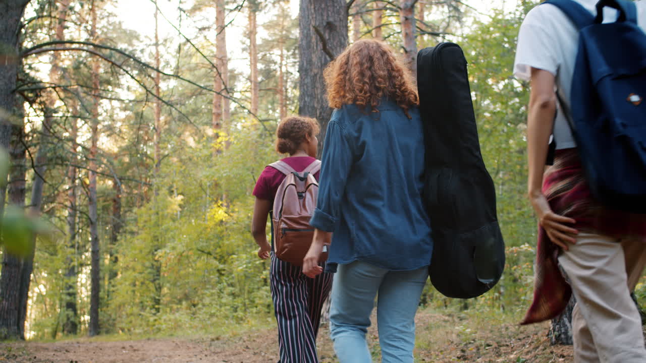 Friends Hiking Through a Forest