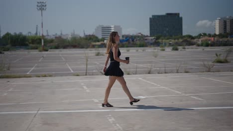 woman walking in an empty parking lot