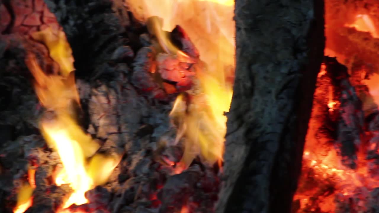 Extreme close-up of glowing charcoal and flickering flames. Perfect for BBQ, campfire, cooking, bonfire, cinematic backgrounds, fireplace loops and intense heat energy visuals.