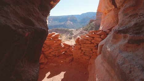 view from inside a cave in sedona arizona panning upwards to reveals ruins