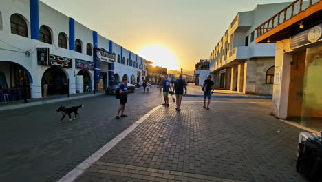 Slow motion shot of locals and tourists exploring Dahab, Egypt during sunset.