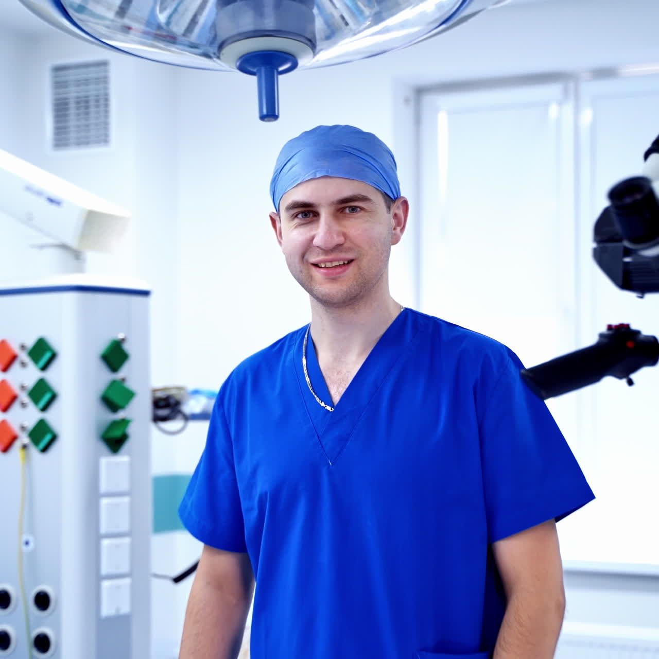 Interior of an operating room in modern clinic. Neurosurgery equipment. Smiling doctor in an operating room. Work at a hospital.