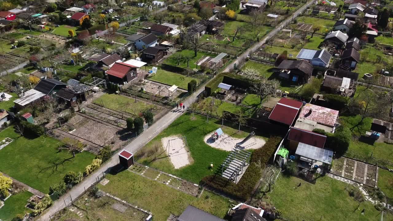 Flight over typical european gardening areas as recreational spaces for suburban folks drone footage
