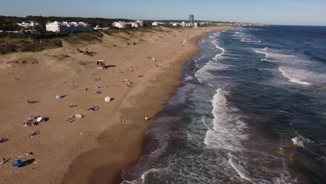 People-sunbathe-on-Playa-Brava-beach-on-sunny-day,-Punta-del-Este-in-Uruguay