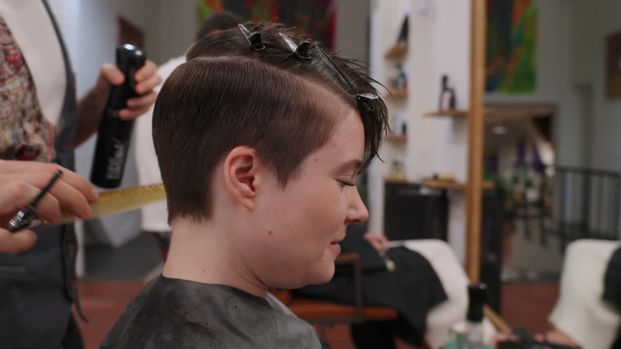 Hairdresser giving a haircut