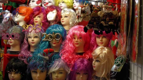 stall at traditional christmas market in plaza mayor selling wigs among prank toys, fancy dress masks, xmas decorations and lights and nativity clay figures