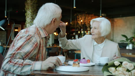 elderly couple enjoying dessert and conversation