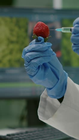 scientist injecting a strawberry in a laboratory