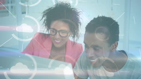 animation of network of connections with clouds over women working in office
