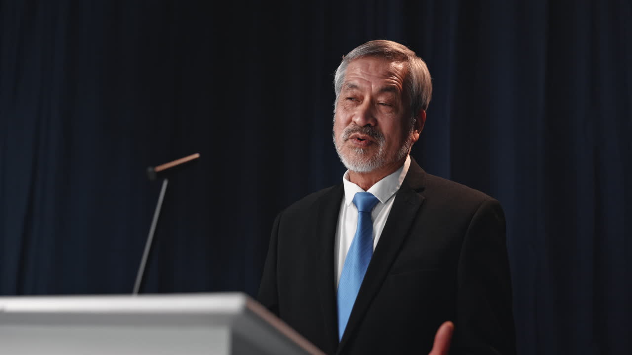 Man giving a speech at a podium
