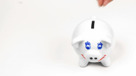 hand putting money in a piggy bank. concept of saving money