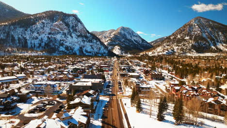 downtown frisco colorado winter bluebird sky daytime snowy aerial drone ten mile range main street mountain ski town copper ikon pass breckenridge silverthorne dillon summit county forward pan motion