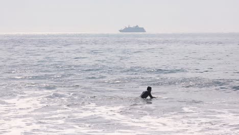 vista cercana de surfistas que intentan surfear sobre el agua clara con algunas olas pequeñas