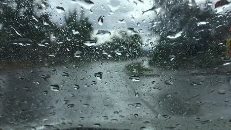 Fire-truck-on-the-street-seen-through-car-wet-window-driving-on-rainy-day