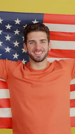 patriotic young man posing with american flag