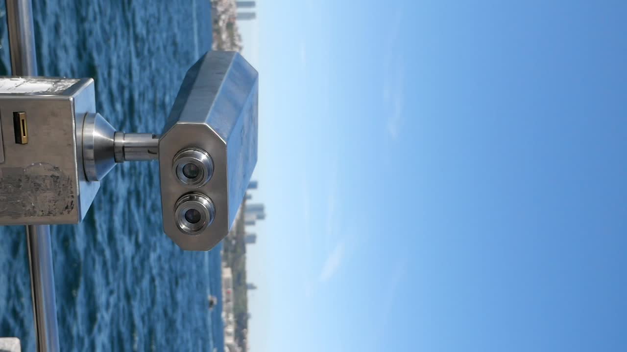 Binoculars overlooking the ocean and city