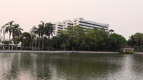 lake and buildings in a serene park setting