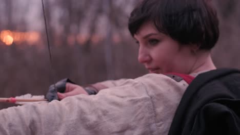 warrior woman shoots a bow in the target