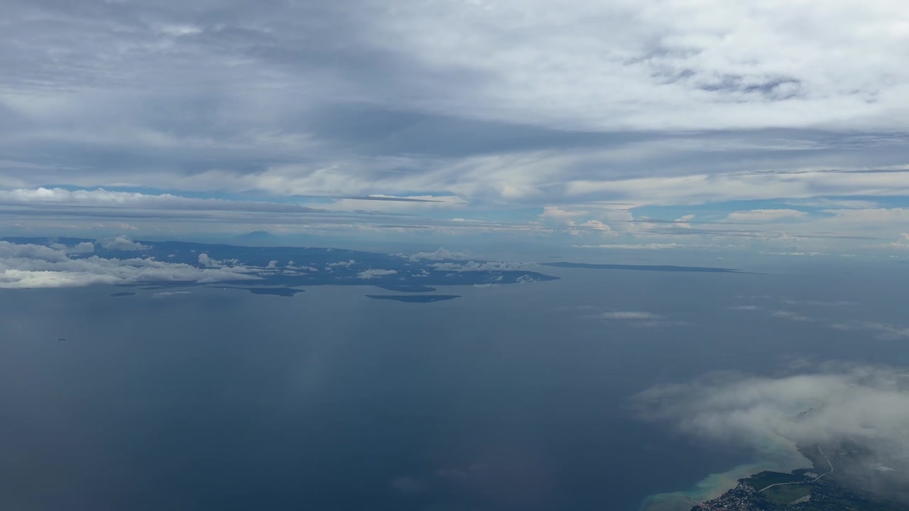 Flight window view over Philippines Pacific Ocean Cebu island Southeast Asia air travel