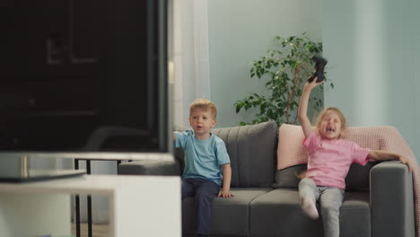 Girl-feels-happy-to-beat-little-brother-playing-video-game