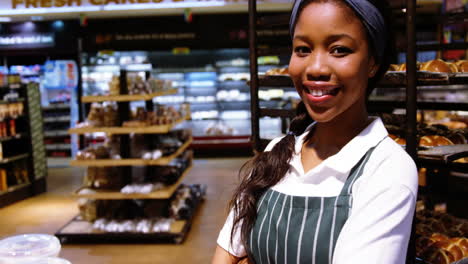 Portrait-of-smiling-female-staff-standing-with-hands-crossed