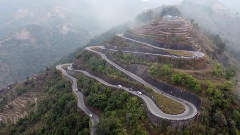 an aerial view of traffic on the bp highway, bardibas highway, showing the switchbacks and turns as it winds through the hills of nepal