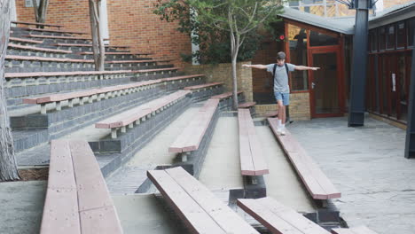 balancing on bench, boy with backpack enjoying outdoor school amphitheater