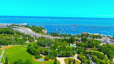 Aerial-flyby-shot-of-Lake-Michigan-next-to-Pritzker-Pavilion-in-Chicago-Illinois-|-Afternoon-Lighting