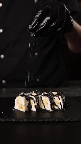 chef preparing chocolate covered banana sushi