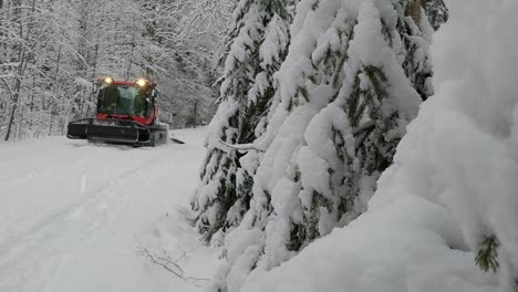 ski trail groomer grooming snow trails in winter forest road