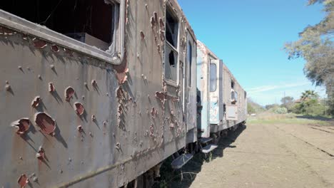 Abandoned-Trains-In-Peloponnese,-Greece-At-Daytime---Panning-Shot