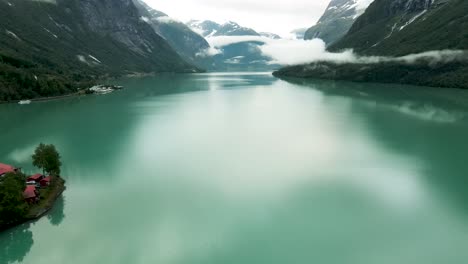 AERIAL:-Flying-over-the-beautiful-turquoise-lake-Loen,-western-Norway