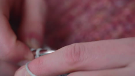 woman's hands doing crochet work, shows how to knit correctly - close up