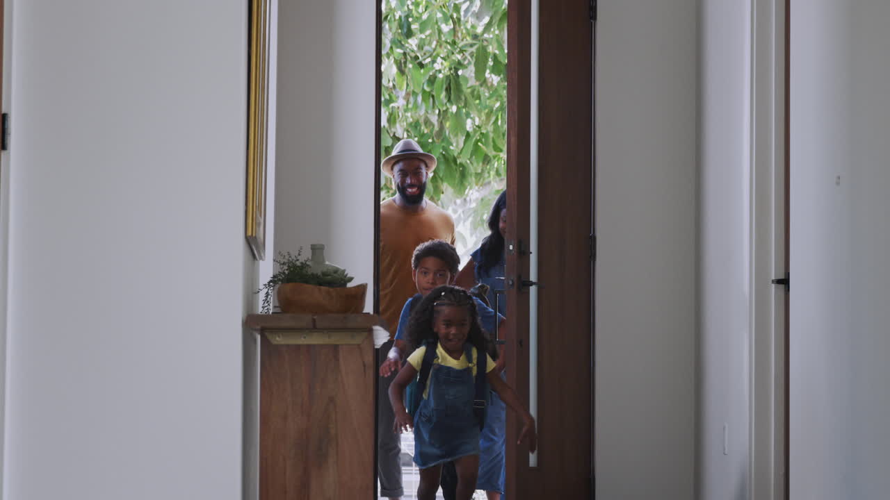 Parents And Children Opening Front Door And Returning Home Together