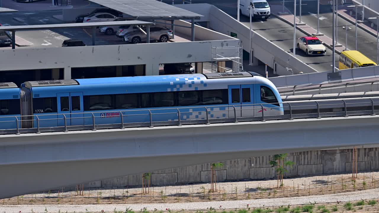 A close-up of a Dubai Metro train as it heads to its next stop along Sheikh Zayed Road in Dubai, UAE.