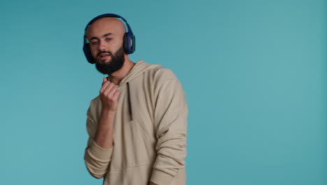 Muslim-person-listening-to-happy-tunes-on-headphones