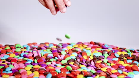 hands interacting with colorful candy on table