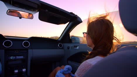 female passenger driving in convertible car shot on r3d