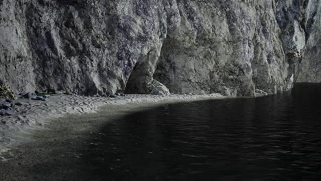 secluded beach with rocky cliffs and calm water at twilight