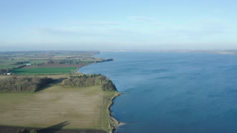 aerial: drone footage of fields and the coastline in jutland, denmark