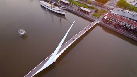 orbiting over puente de la mujer in puerto madero, modern pedestrian rotating bridge, buenos aires