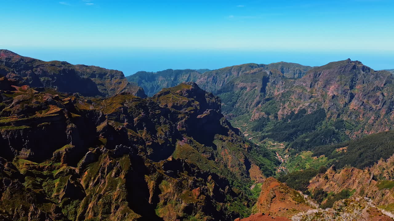 Dangerous high bare rocks with mosses growing on. Lovely clear sky at backdrop. Drone footage.