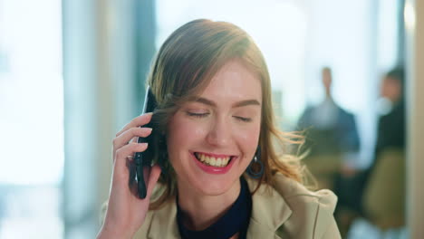 smiling businesswoman talking on phone in office