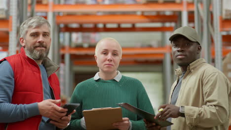 diverse team of warehouse workers looking at camera
