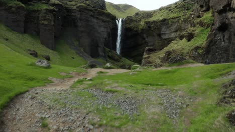 Rising-from-green-slope-to-reveal-stunning-Kvernufoss-waterfall-in-iceland-gorge